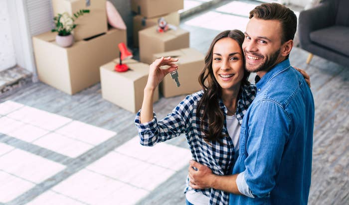 A couple holding the keys to their new home
