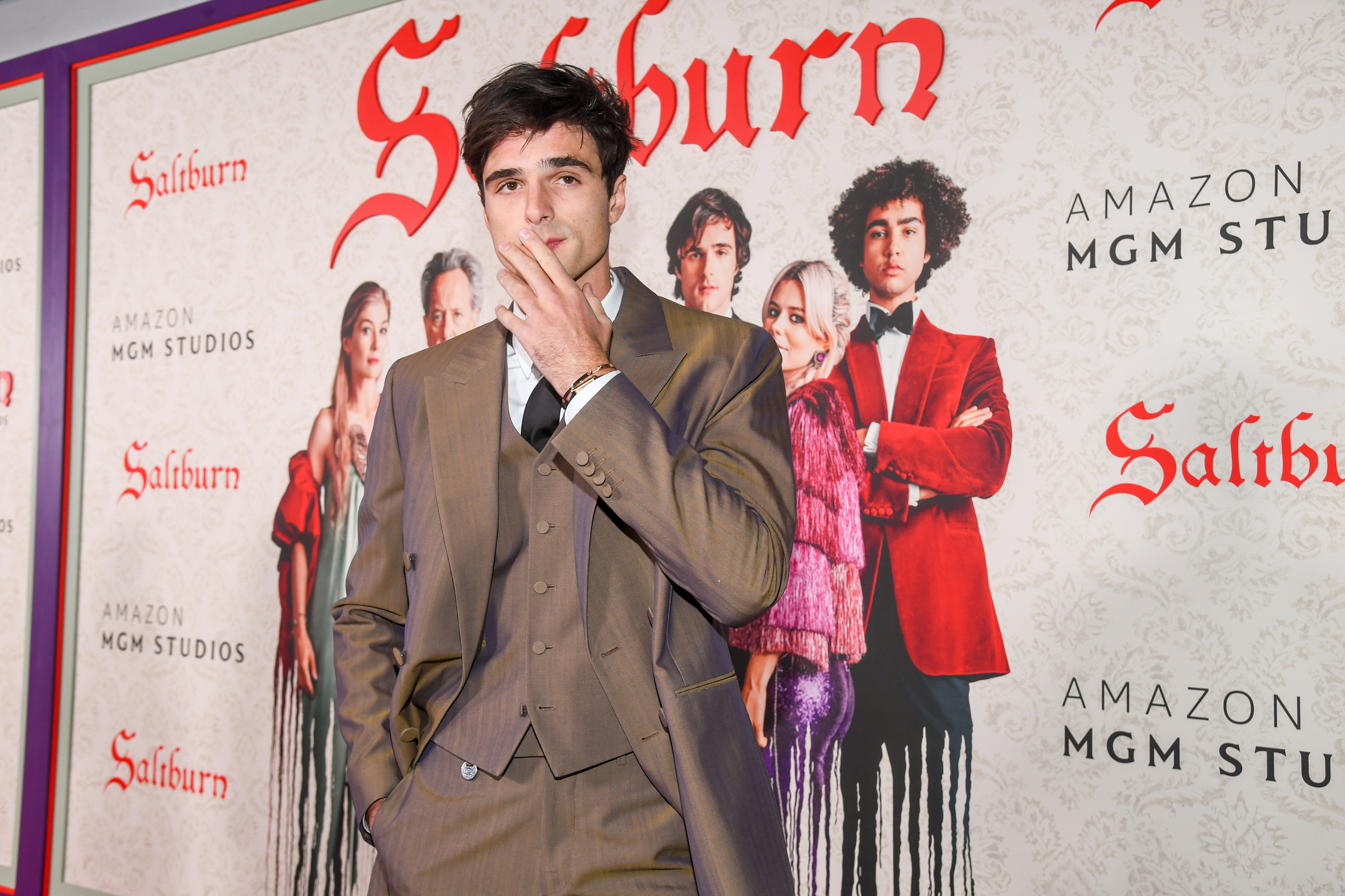 Jacob Elordi in front of the &quot;Saltburn&quot; promotional poster