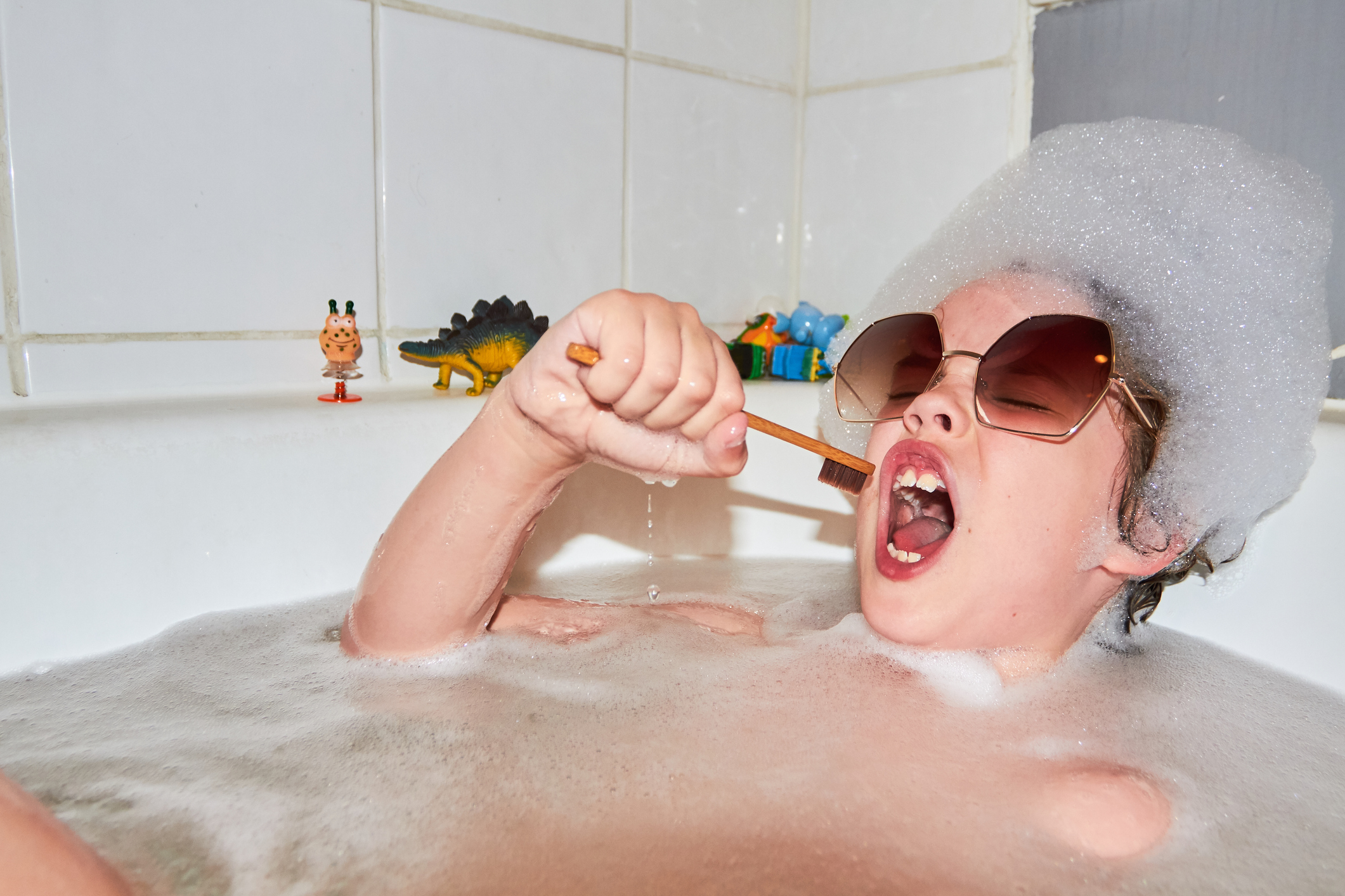 A kid is taking a bubble bath