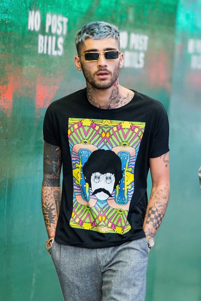 Closeup of Zayn Malik walking with his hands in his pockets