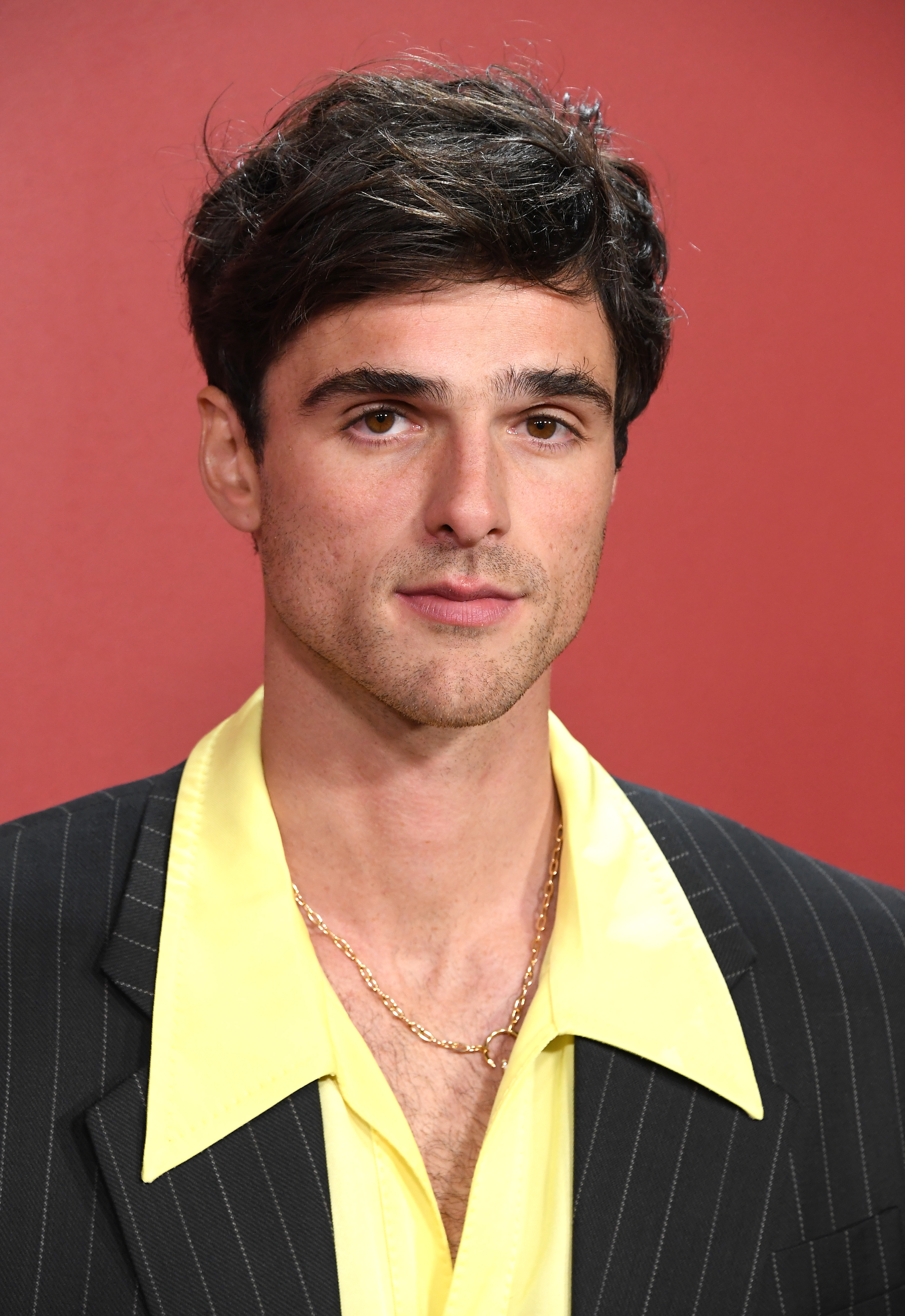 A close-up of Jacob in a pin-striped suit jacket and a shirt