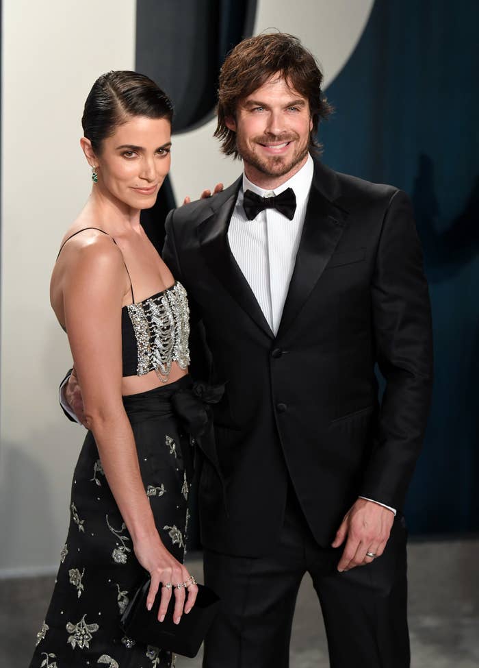 The couple, in formalwear,  pose on the red carpet