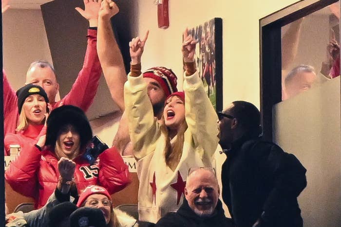 Taylor Swift cheering with other football fans