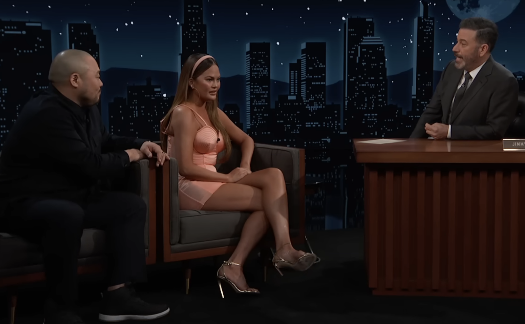 Chrissy and David sitting on the talk show with Jimmy