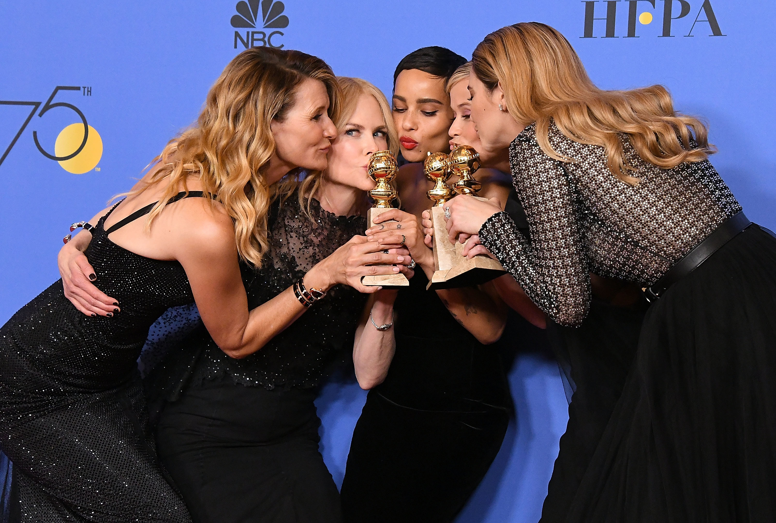 The cast kissing their  Golden Globe awards backstage