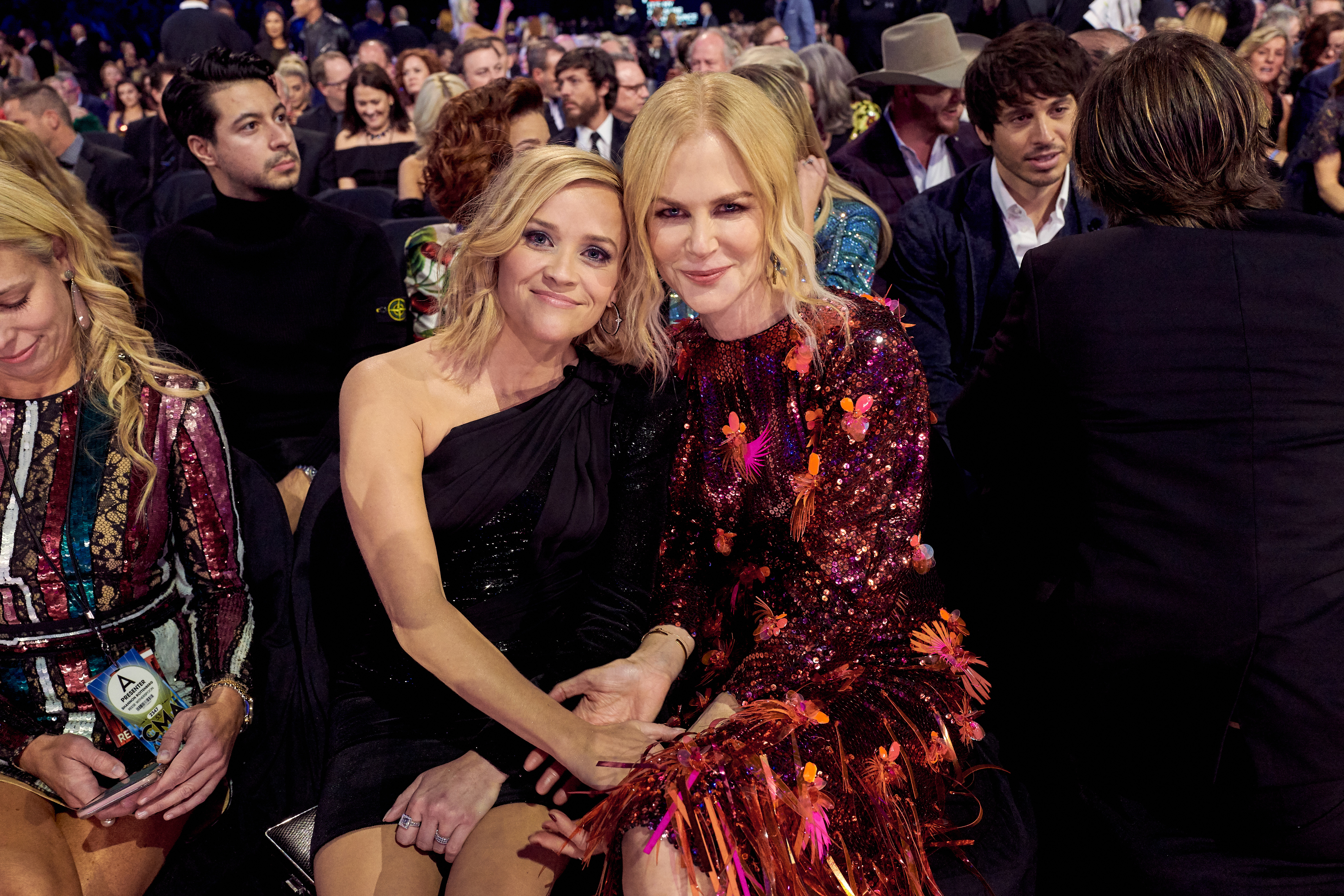 Close-up of Nicole and Reese sitting together and leaning in toward each other