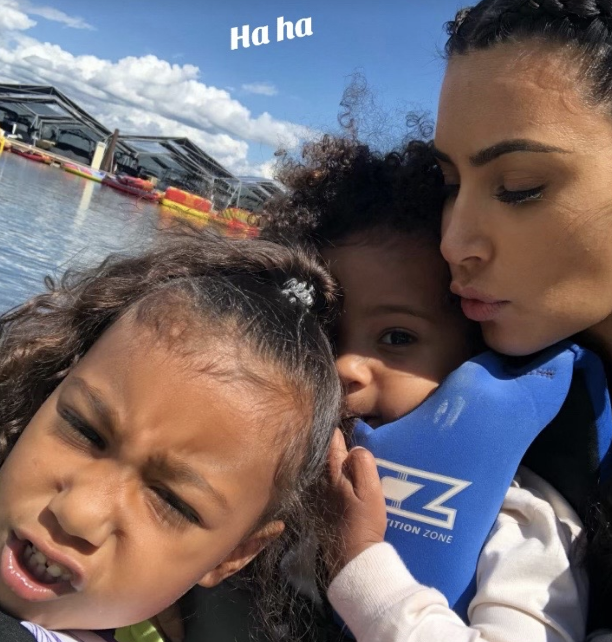 Close-up of Kim with two children by the water