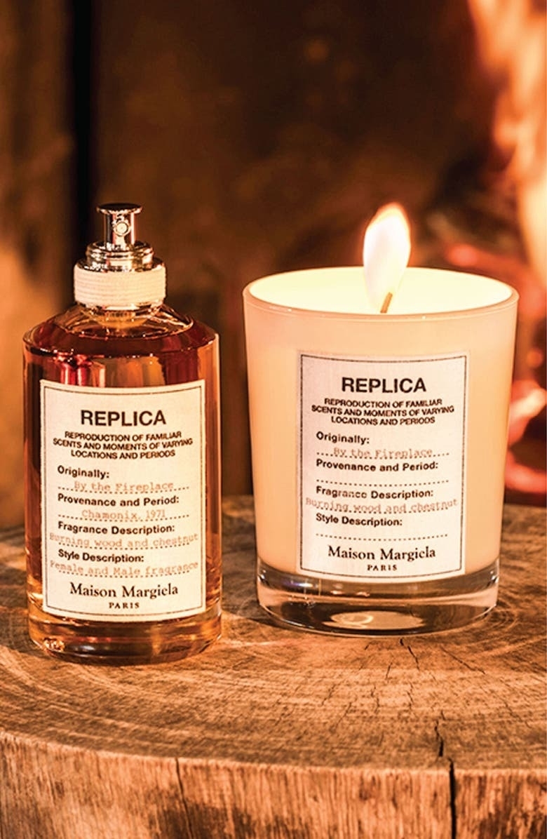 the lit Replica By the Fireplace scented candle