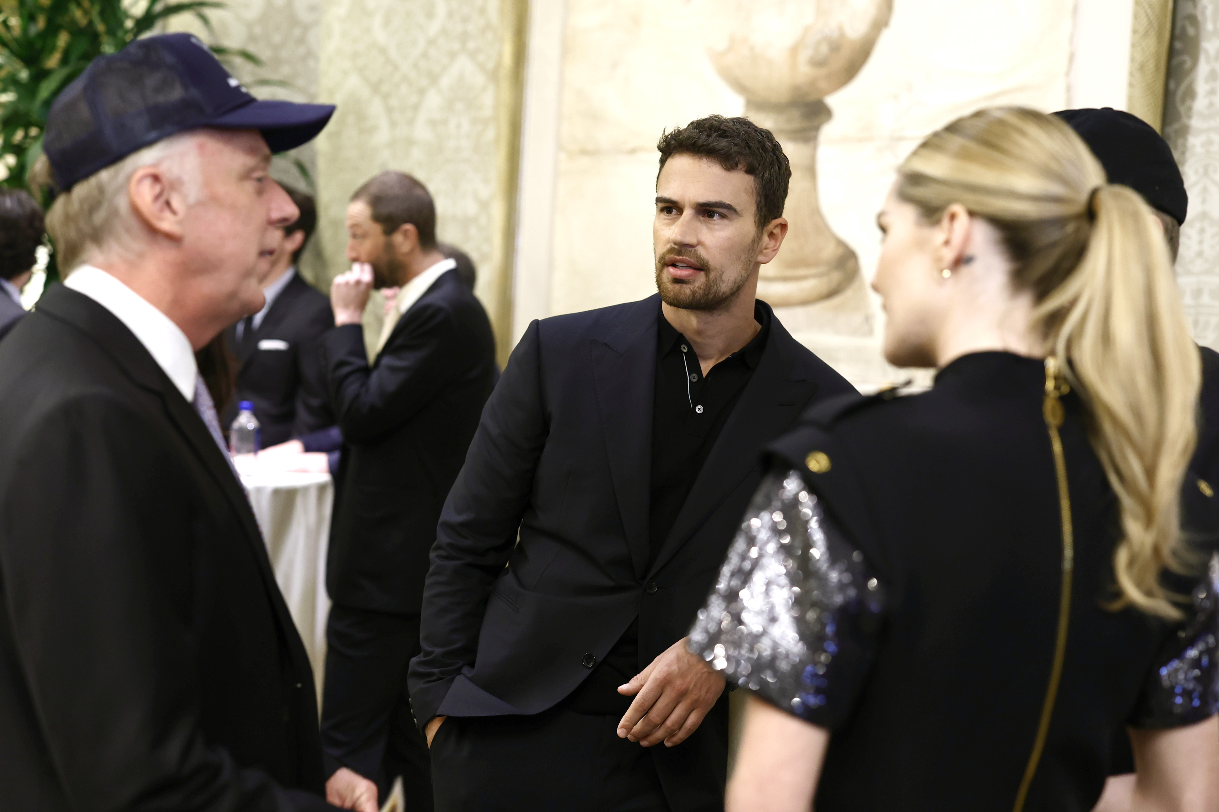 Mike White, Theo James, and Meghann Fahy at an event
