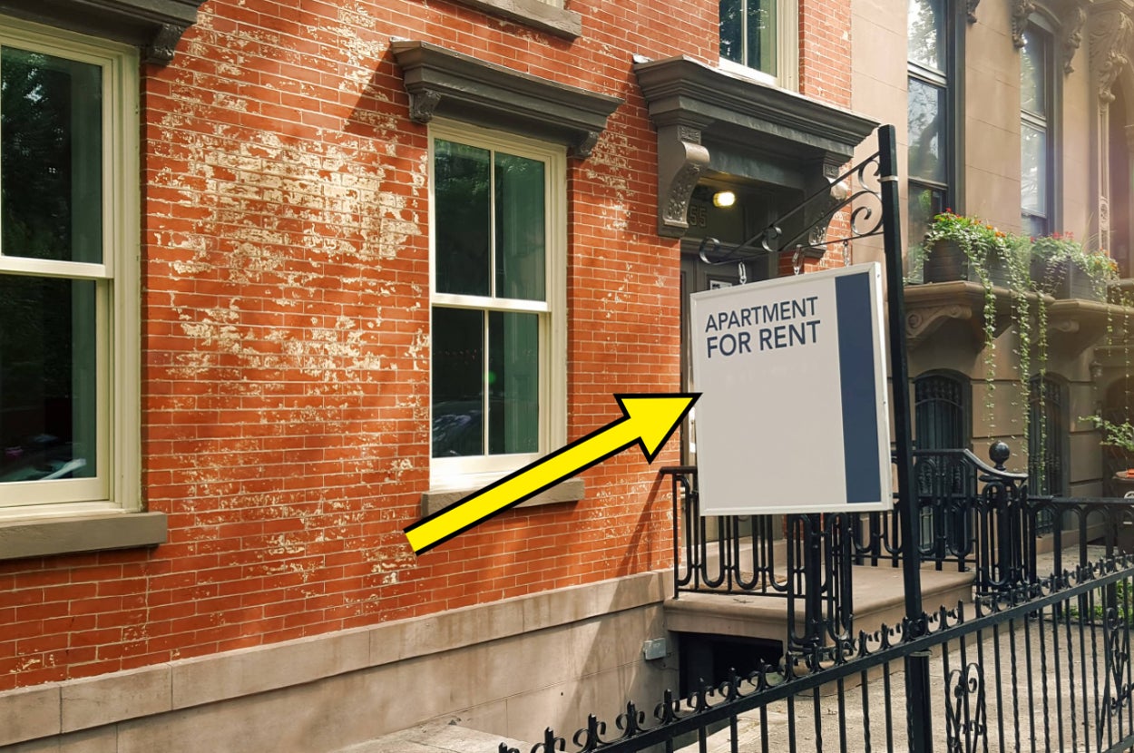 an "apartment for rent" sign in front of a building