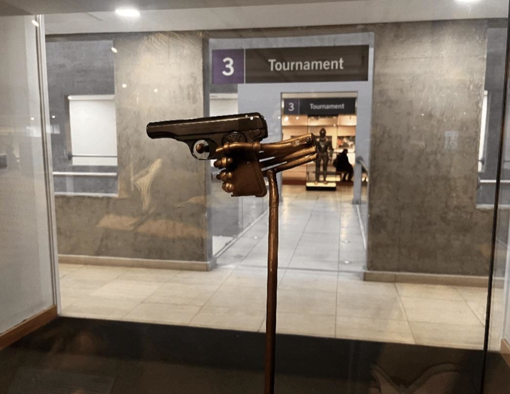 A gun behind glass on a pedestal