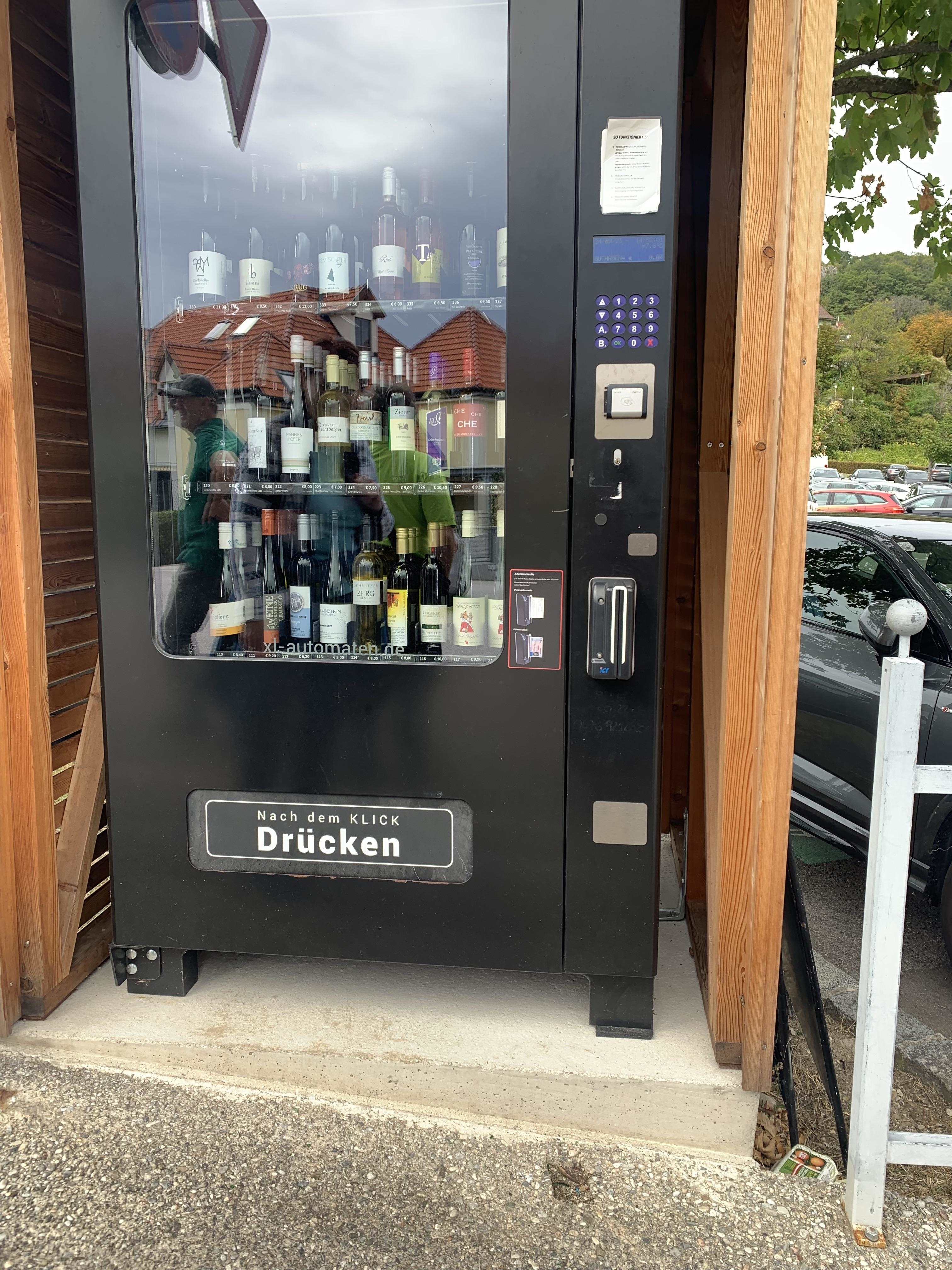 A vending machine containing bottles of wine