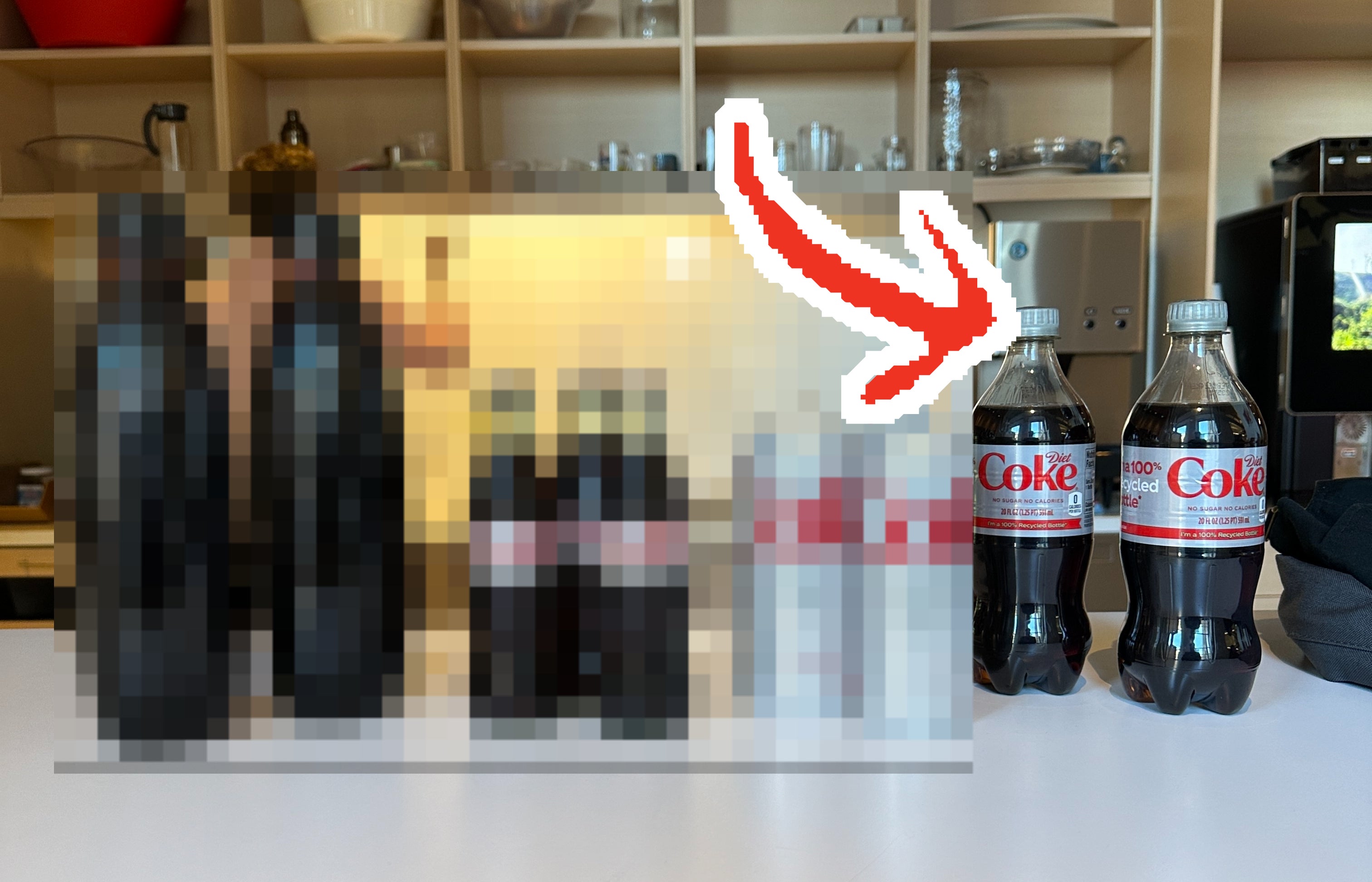 The four different types of Diet Coke lined up on a table, with an arrow pointing to the plastic bottle