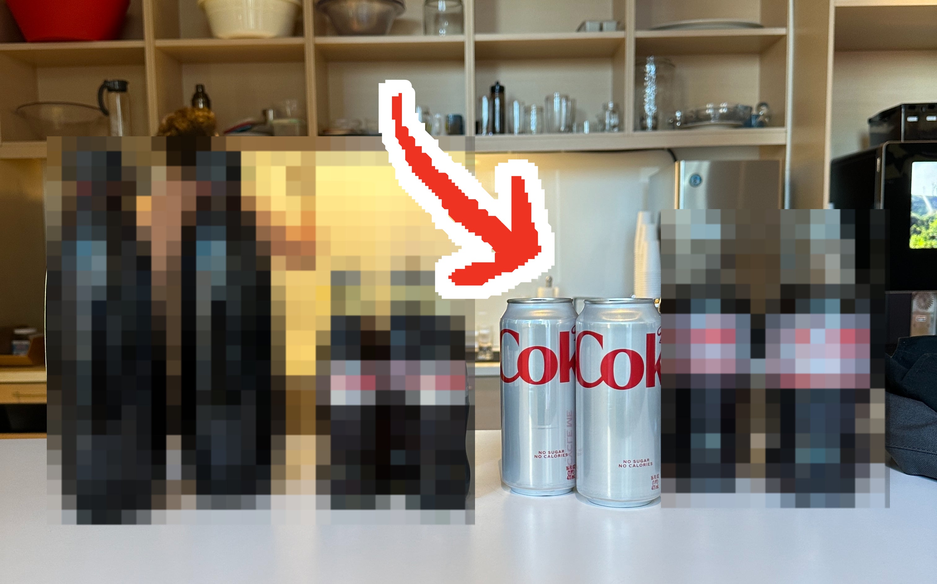The four different types of Diet Coke lined up on a table, with an arrow pointing to the can