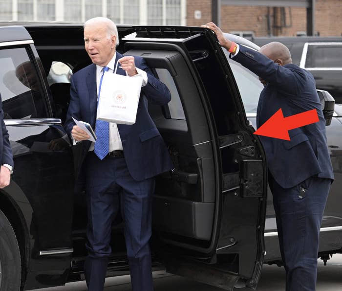 A Secret Service agent opening a car door for President Joe Biden