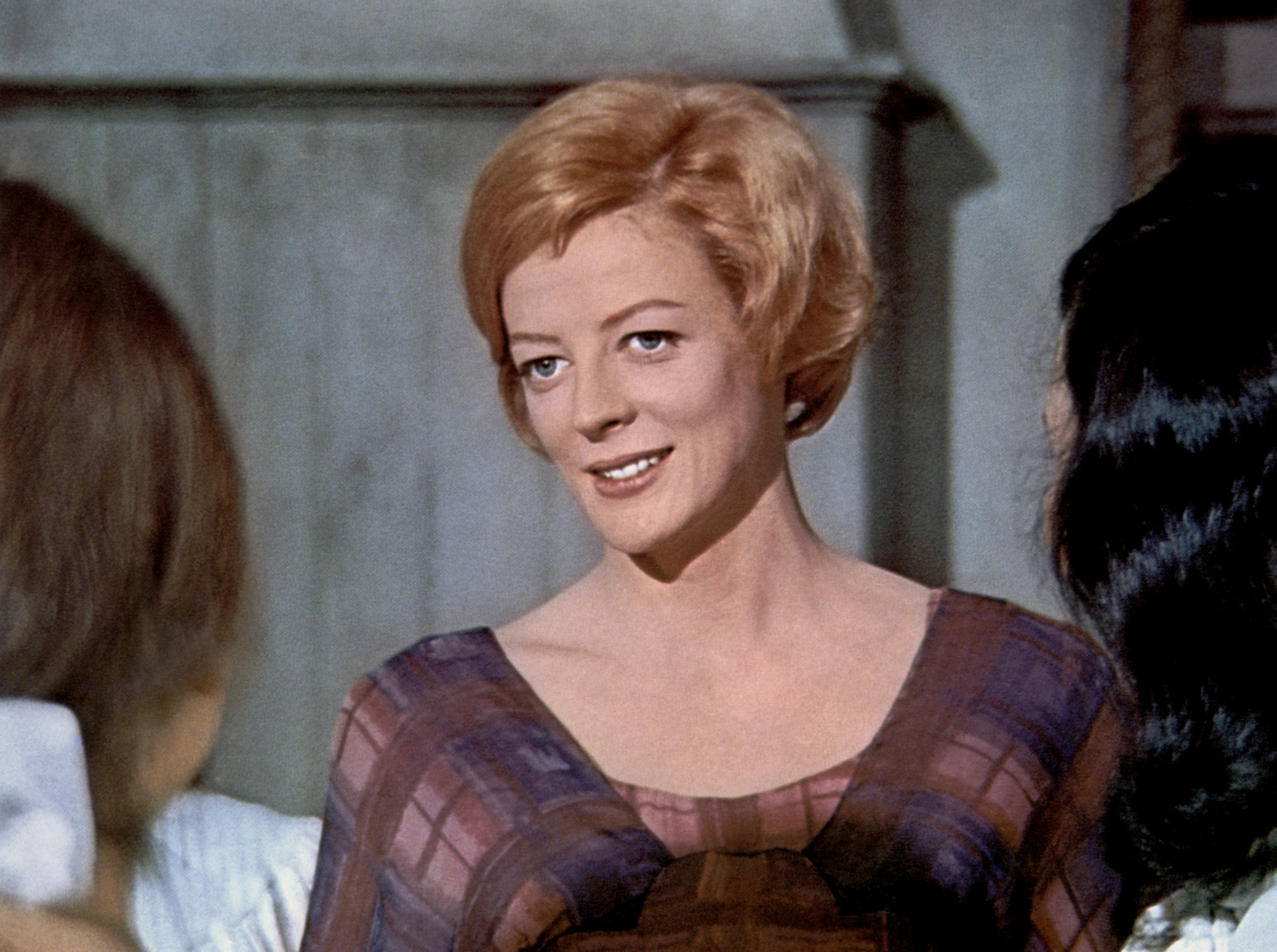 Maggie Smith in the &quot;Prime of Miss Jean Brodie.&quot; She is speaking to two woman and wearing a checkered dress.