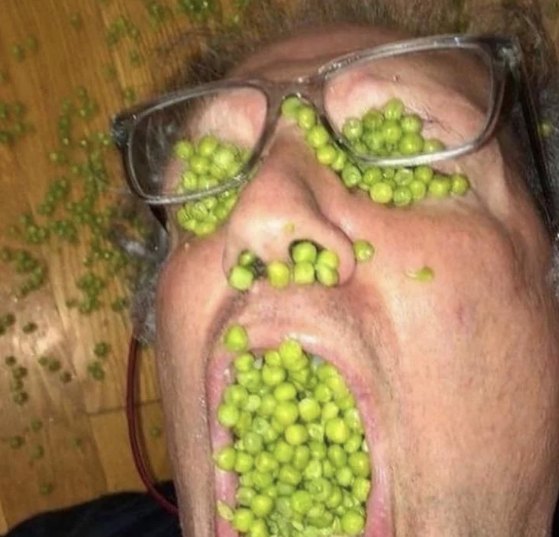eyes, nose, and mouth are filled with peas