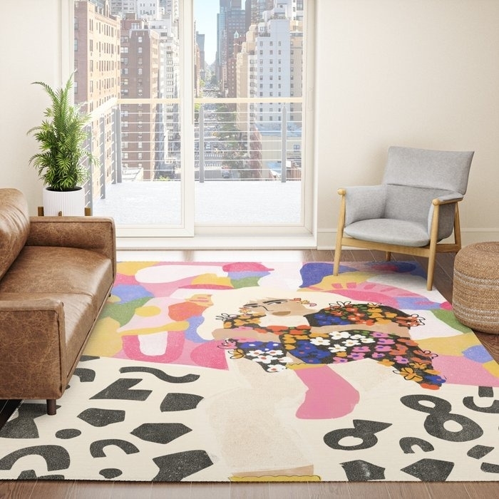 rainbow color-blocked rug with illustration of a person wearing a floral sweater
