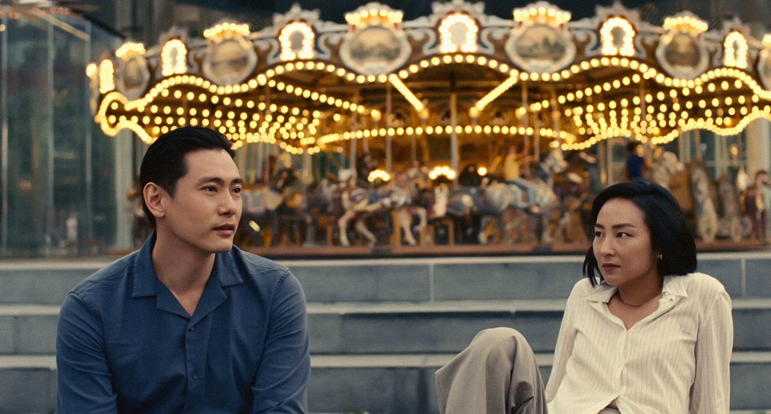 characters sitting outside a carousel