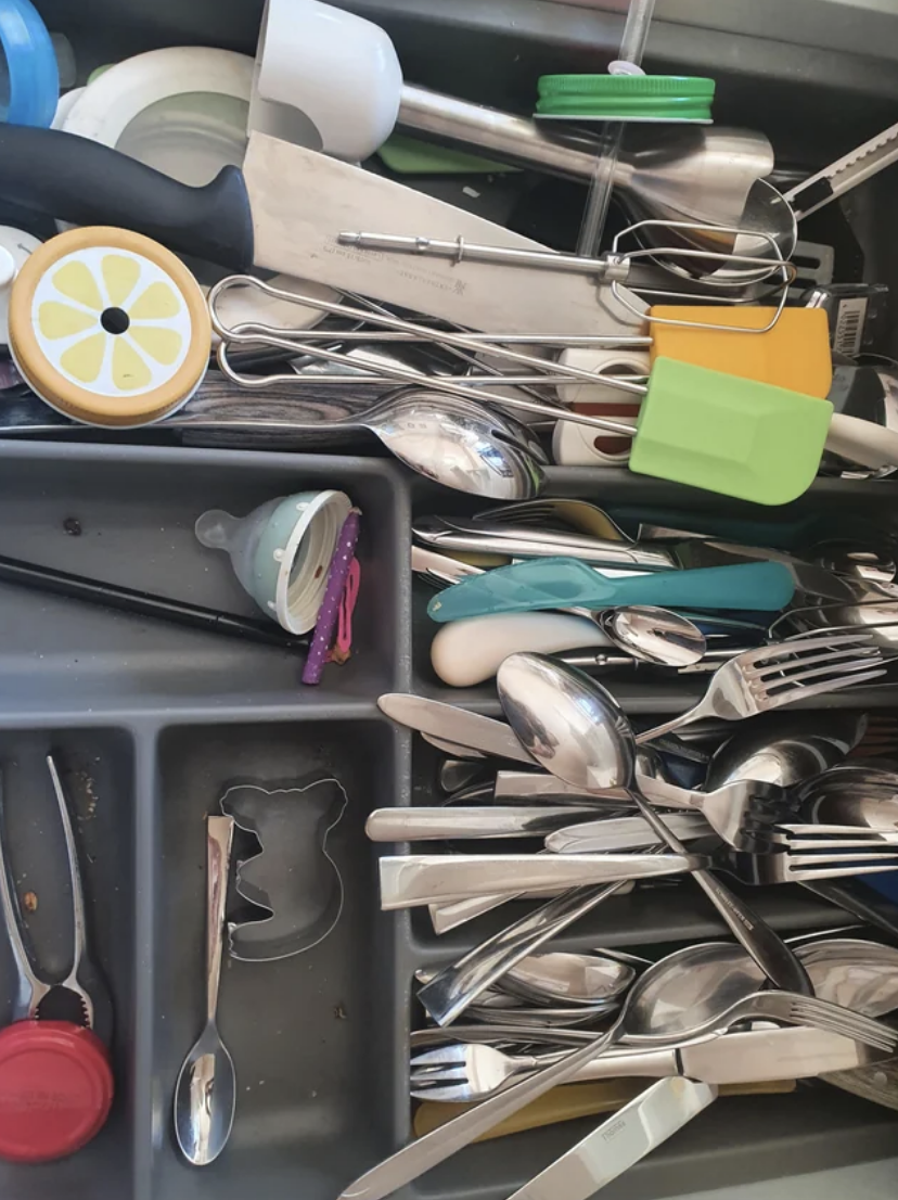 a disorganized cutlery drawer
