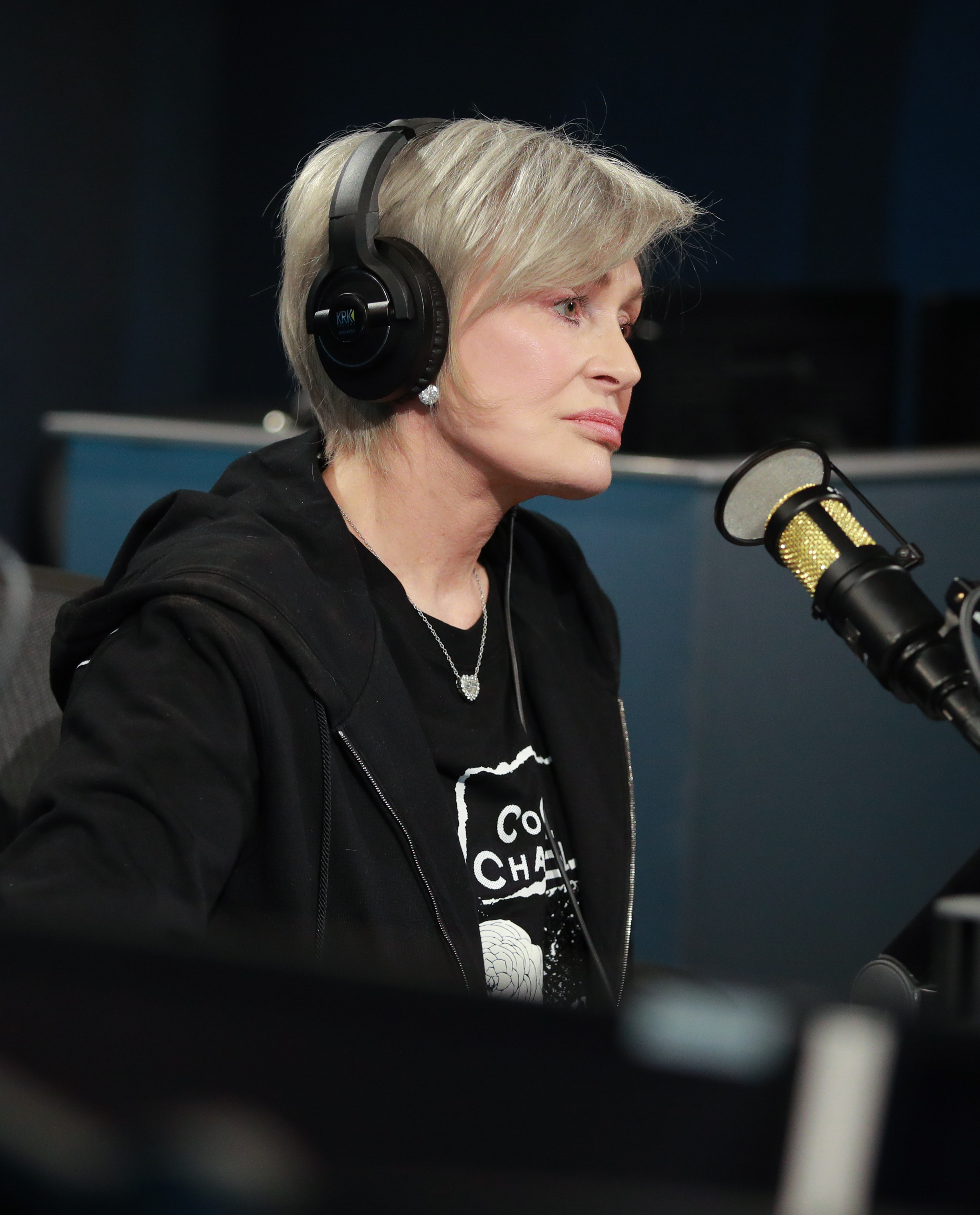 Sharon sitting in front of a mic during an interview