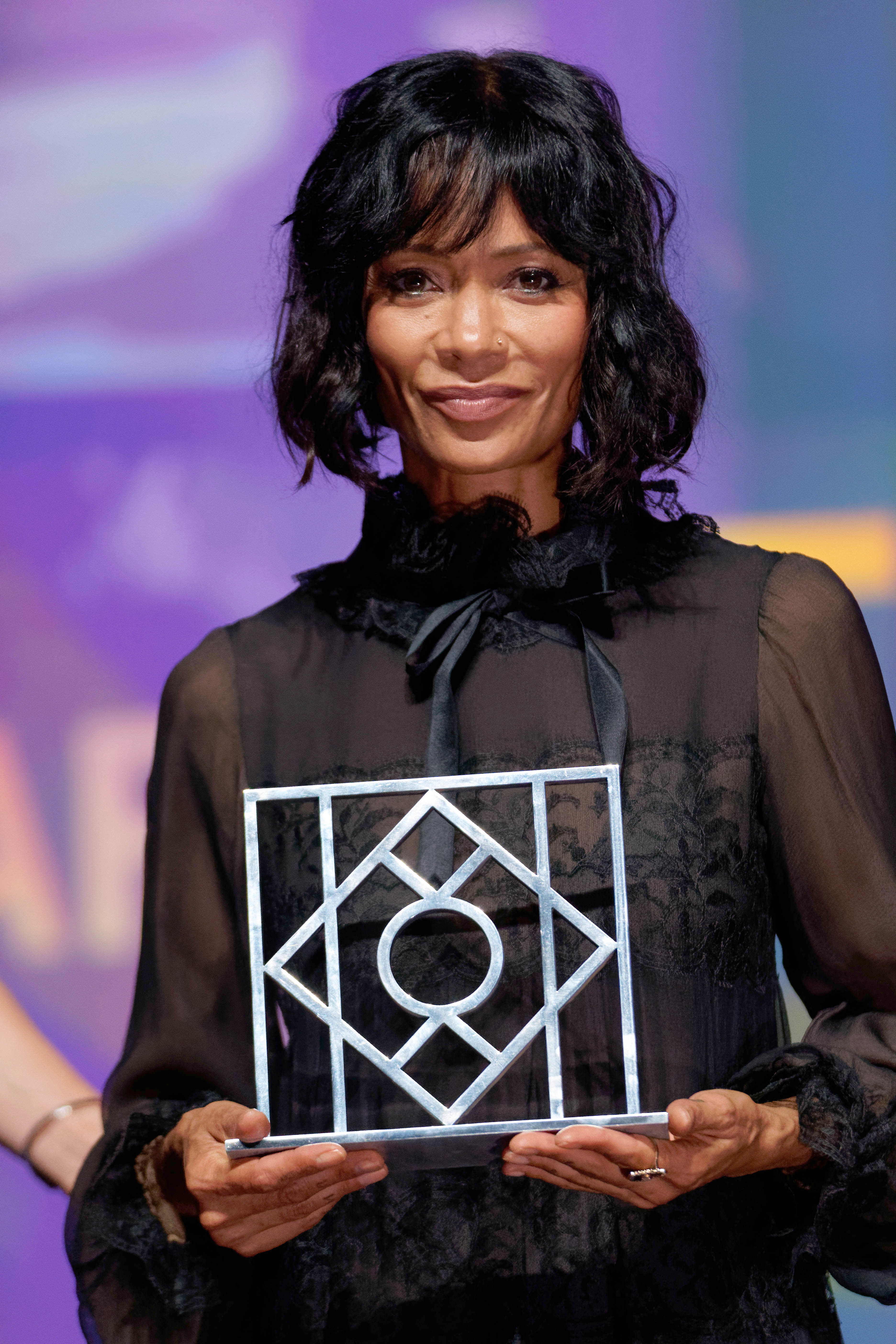 Close-up of Thandiwe holding an award