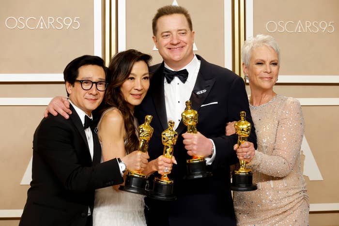 Ke Huy Quan, Michelle Yeoh, Brendan Fraser, and Jamie Lee Curtis holding up their awards