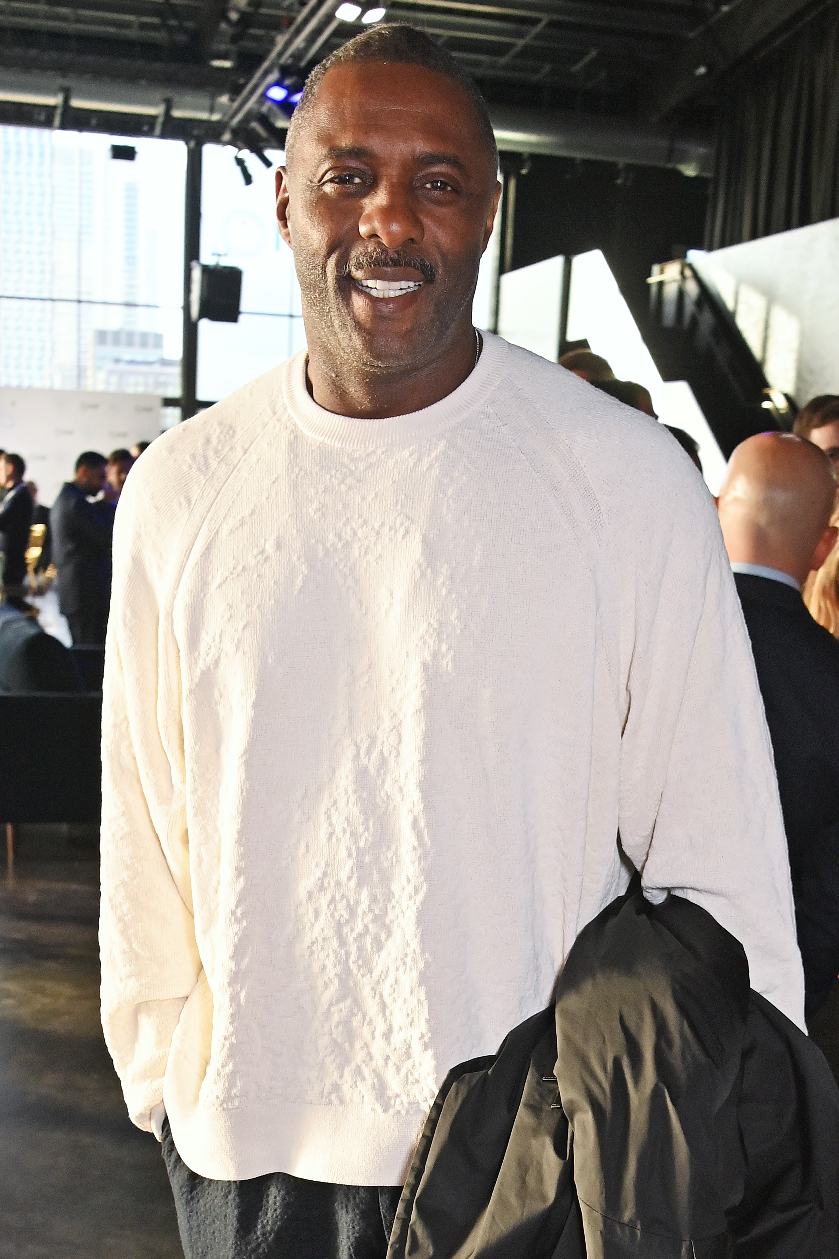 Close-up of Idris wearing a sweater