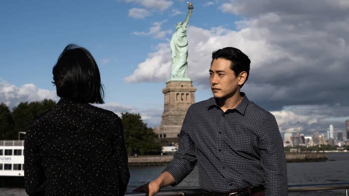 The characters from &quot;Past Lives&quot; seeing the Statue of Liberty by boat.