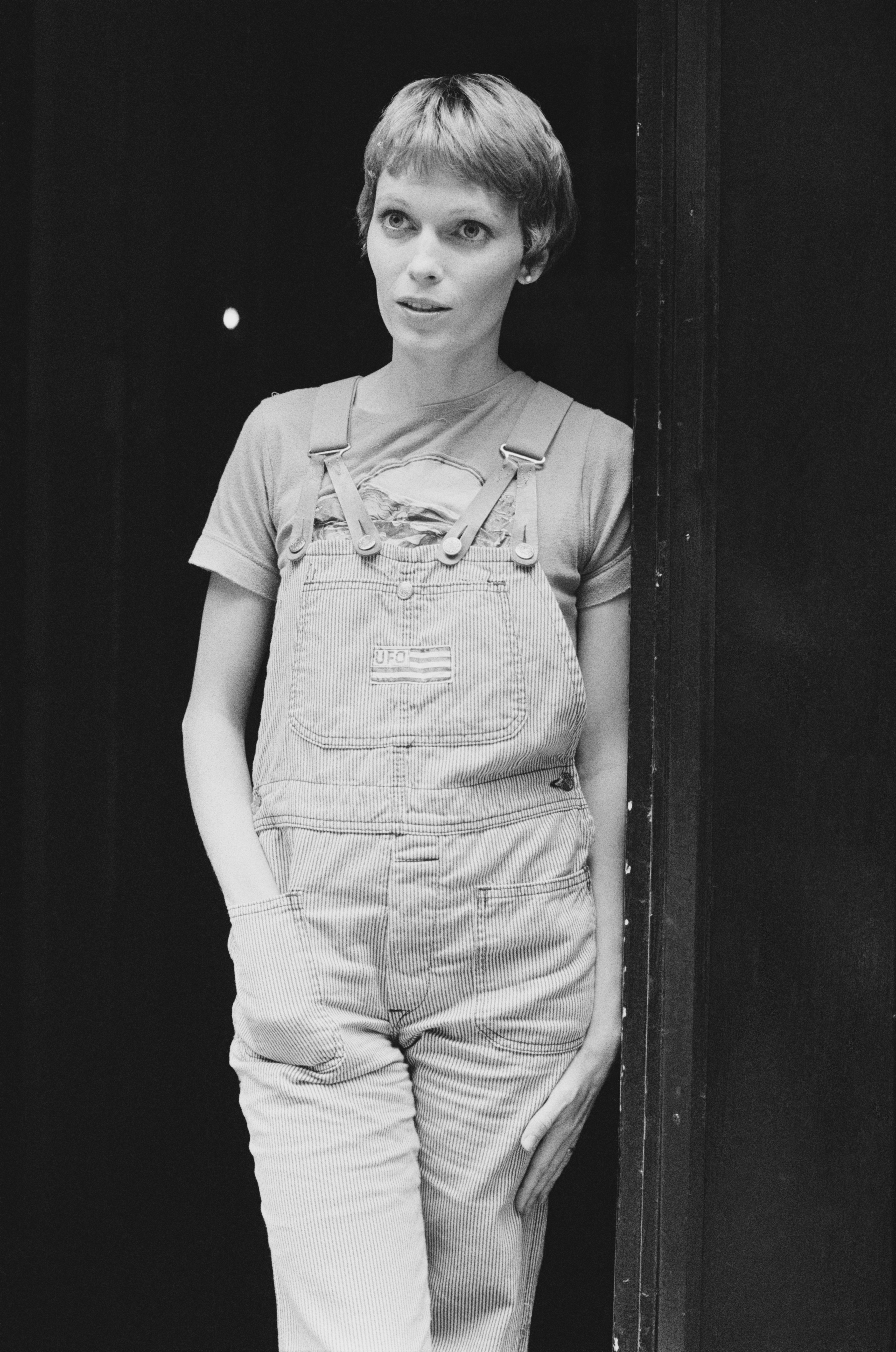 Close-up of a younger Mia in overalls and shirt