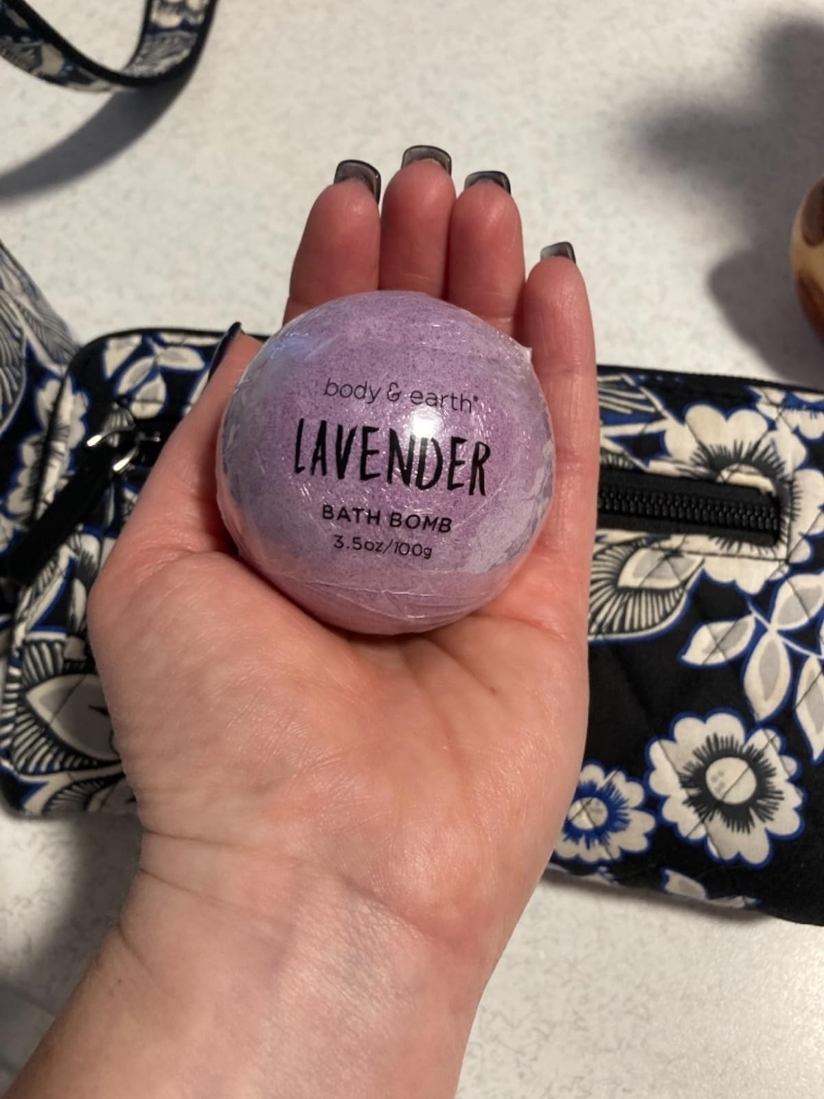 reviewer holding purple lavender bath bomb