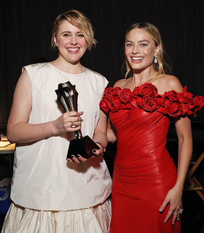 closeup of the two holding an award