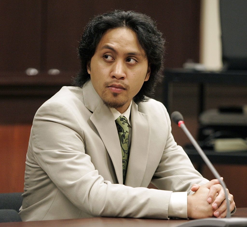 closeup of Vili in a suit sitting in court