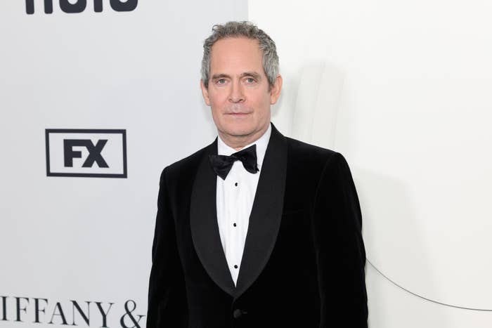 Close-up of Tom Hollander in a bow tie at a media event