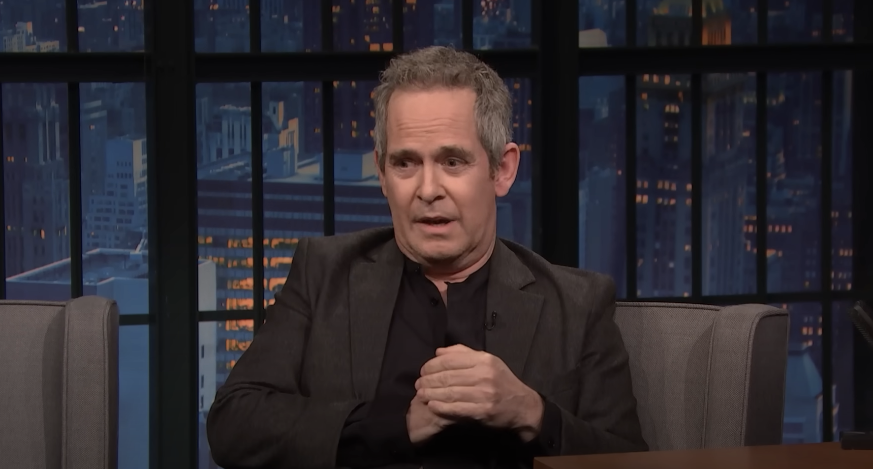 Close-up of Tom Hollander on the talk show