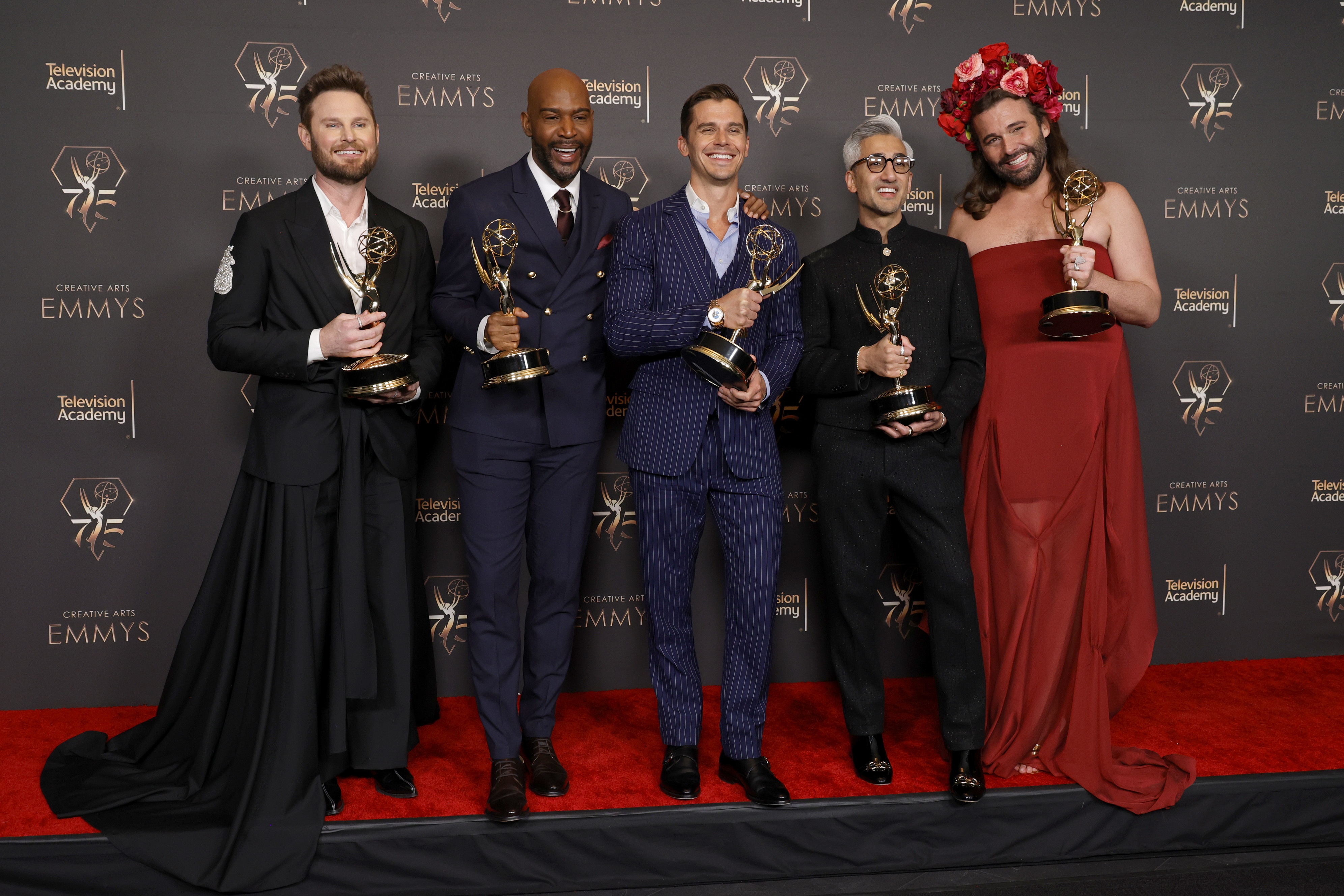 the hosts holding awards on the red carpet