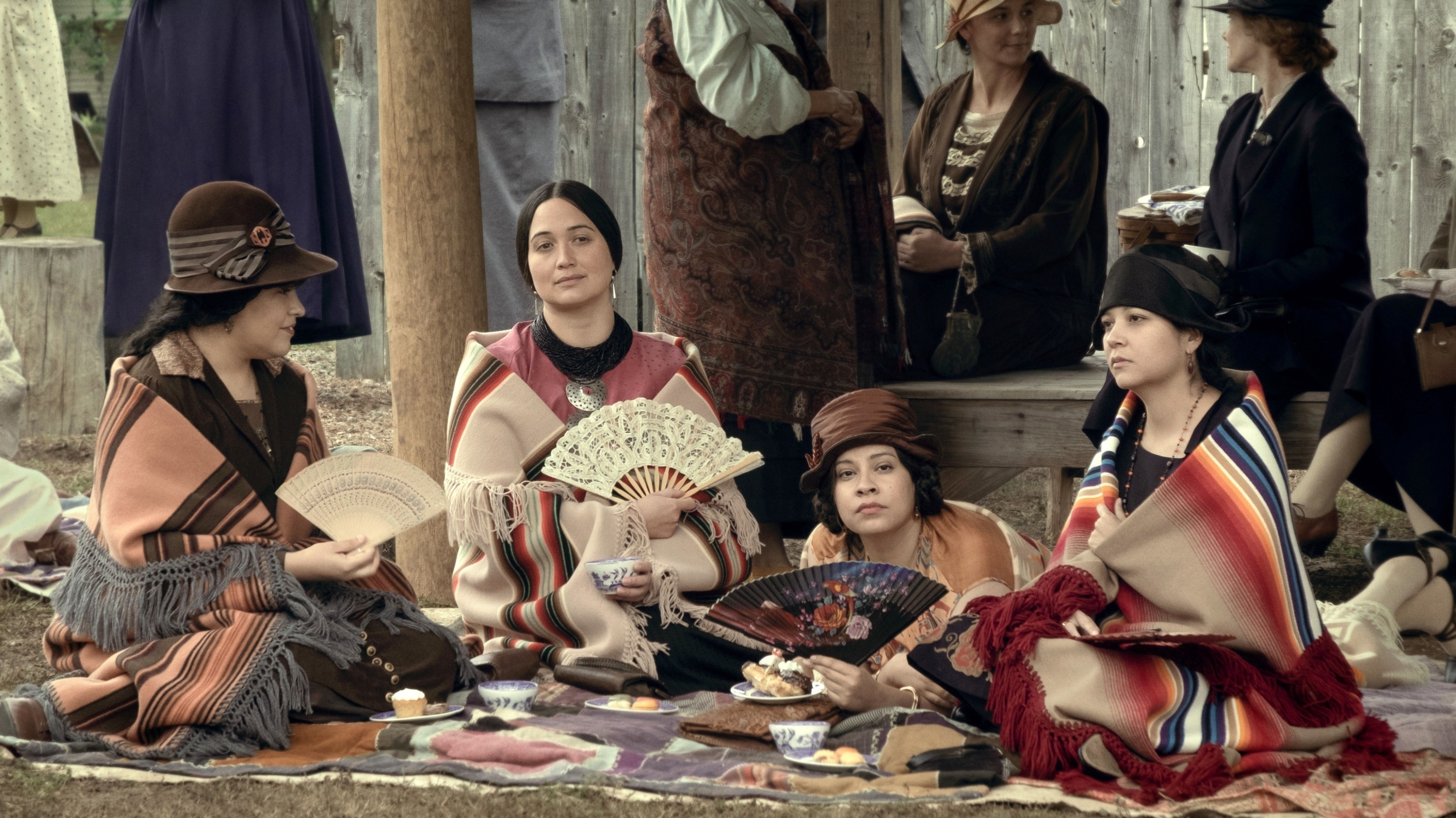 Lily sitting with other women in a scene from &quot;Killers of the Flower Moon&quot;