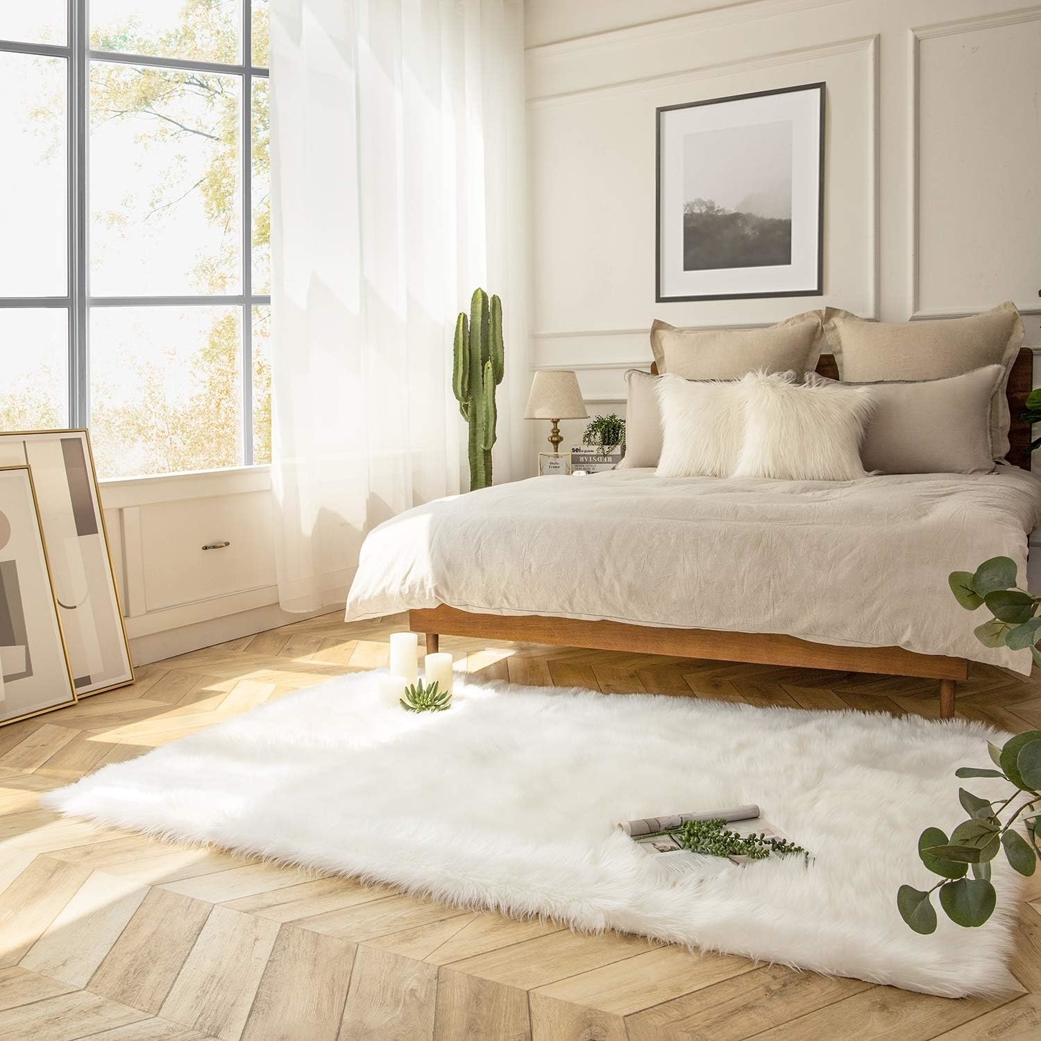 the white sheepskin rug in front of a bed