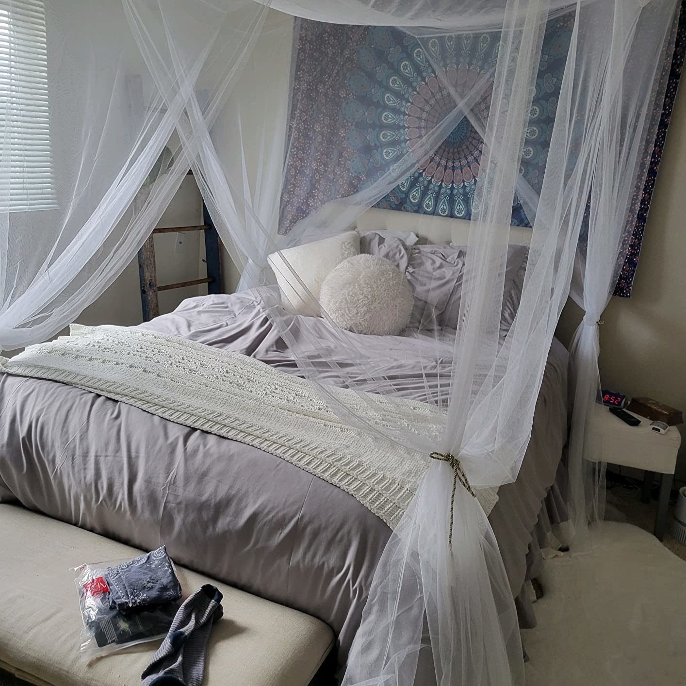 a bed canopy strung up above a bed