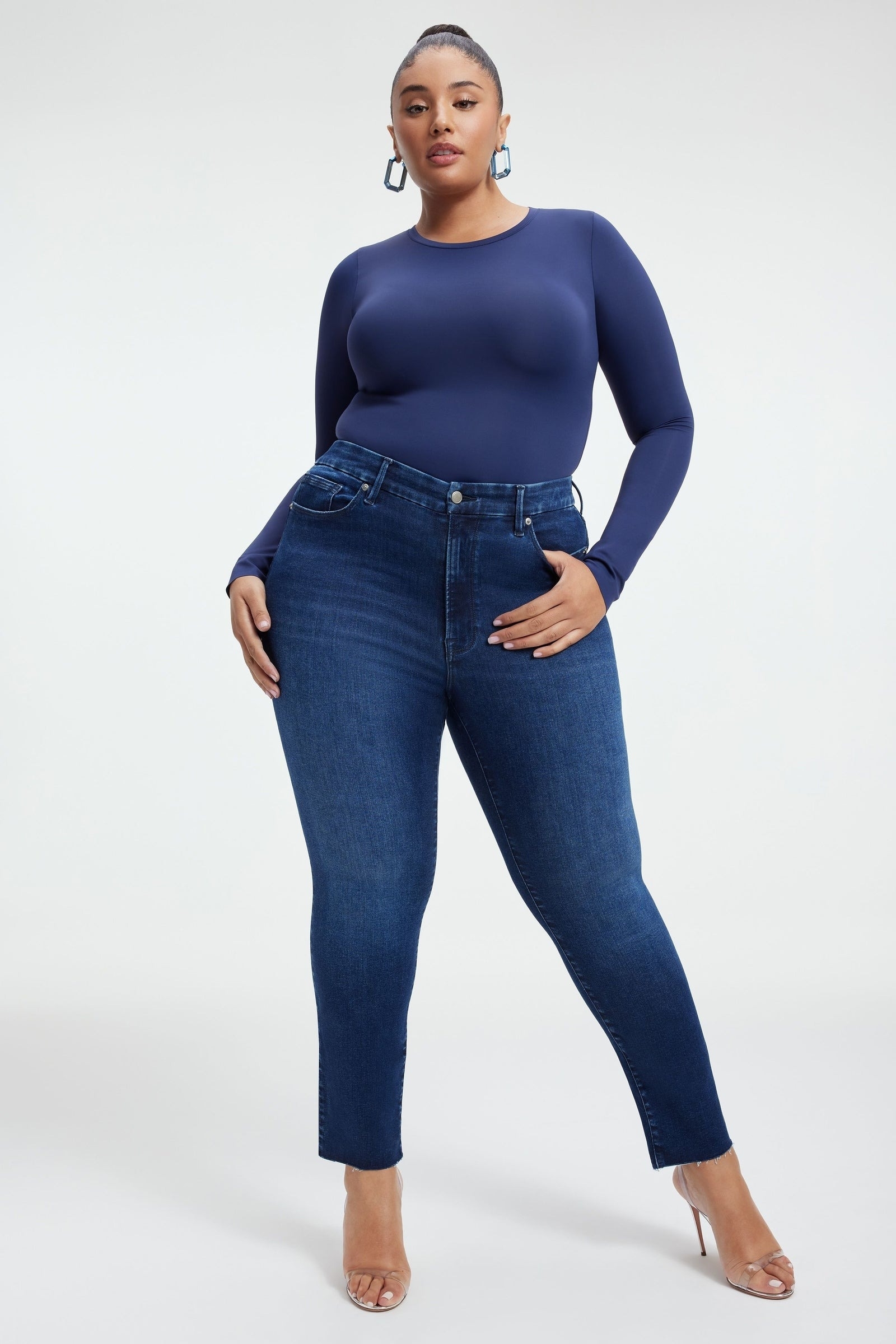 a model wearing the deep blue jeans