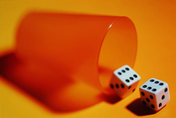 dice spilling from a cup