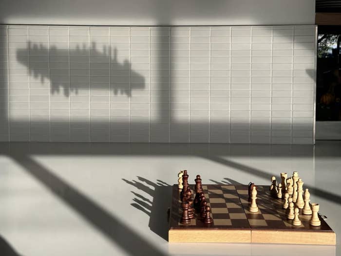 a floating shadow of a chessboard