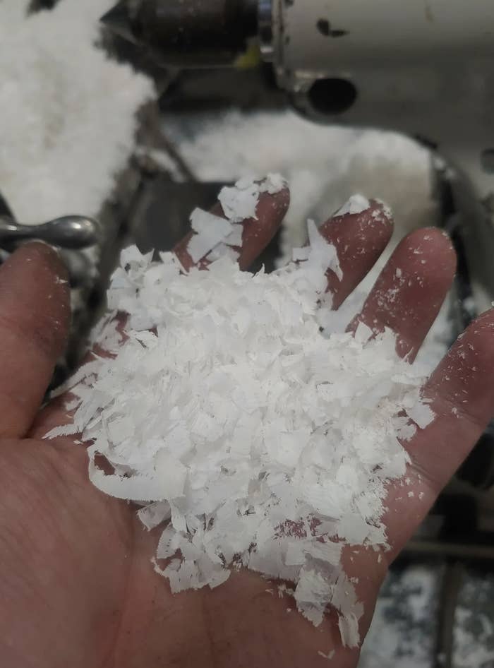 The white shavings are held in a hand