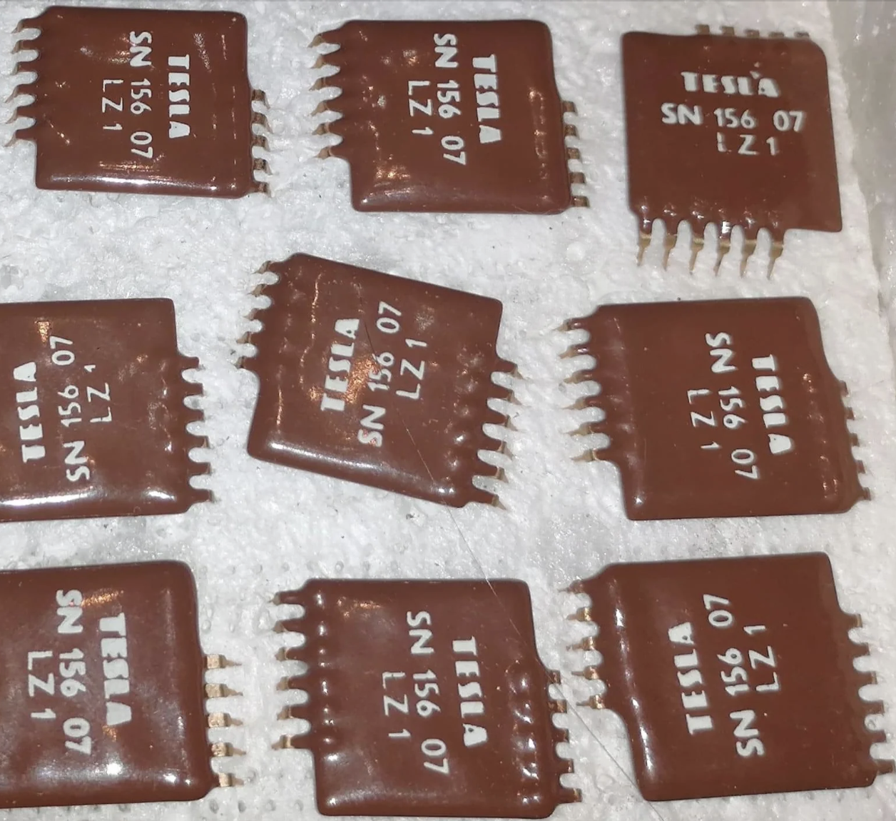They look like chocolate squares with &quot;Tesla&quot; and a code number on them