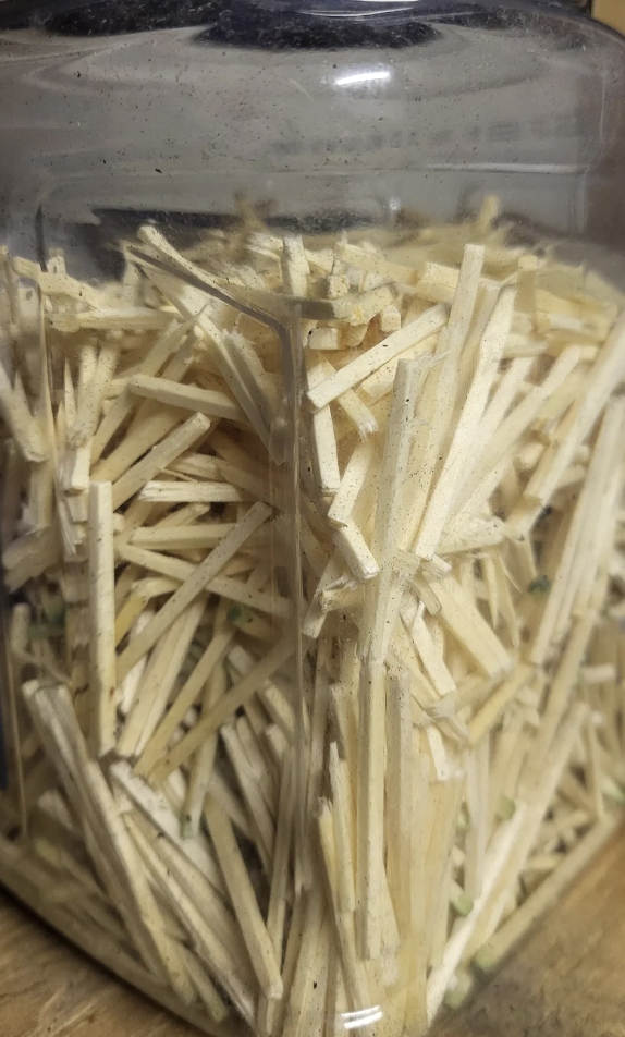 Matchsticks in a glass jar that look a bit like potato sticks