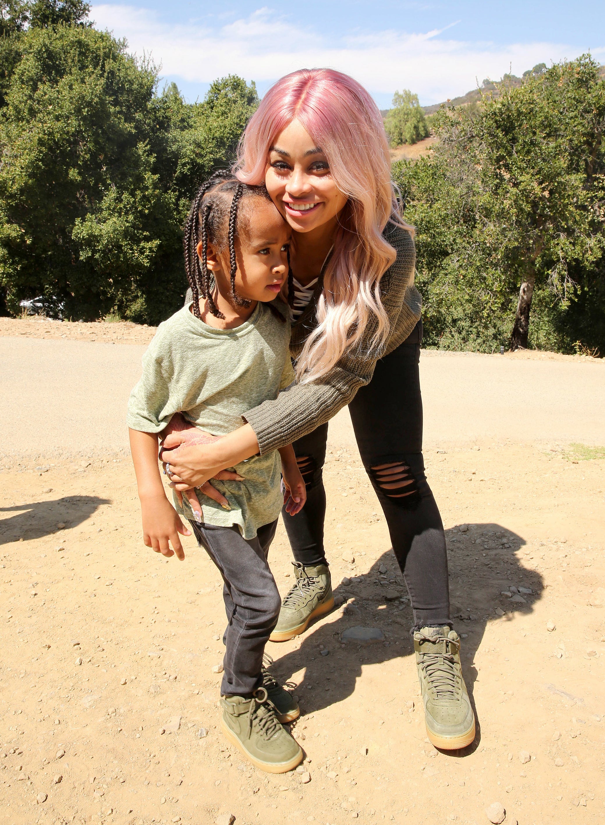 Close-up of Chyna embracing one of her children outdoors