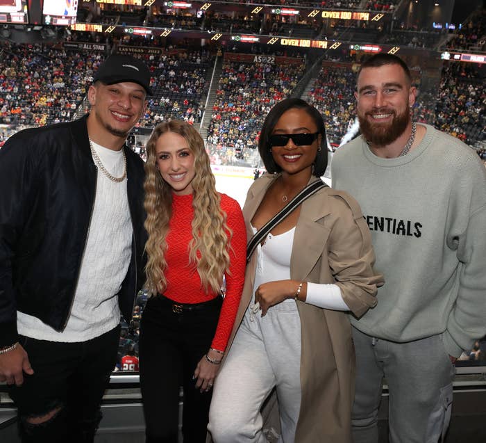 Travis and Kayla smiling with Patrick and Brittany at a sports event