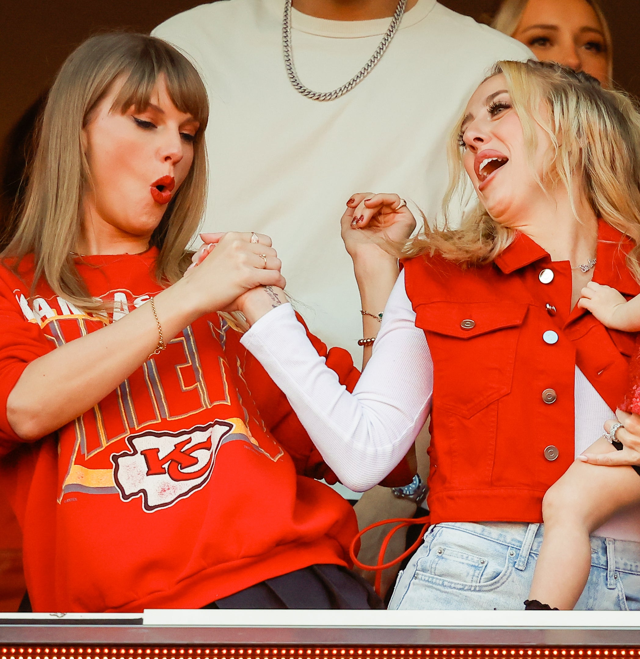 Close-up of Taylor and Brittany celebrating at a football game