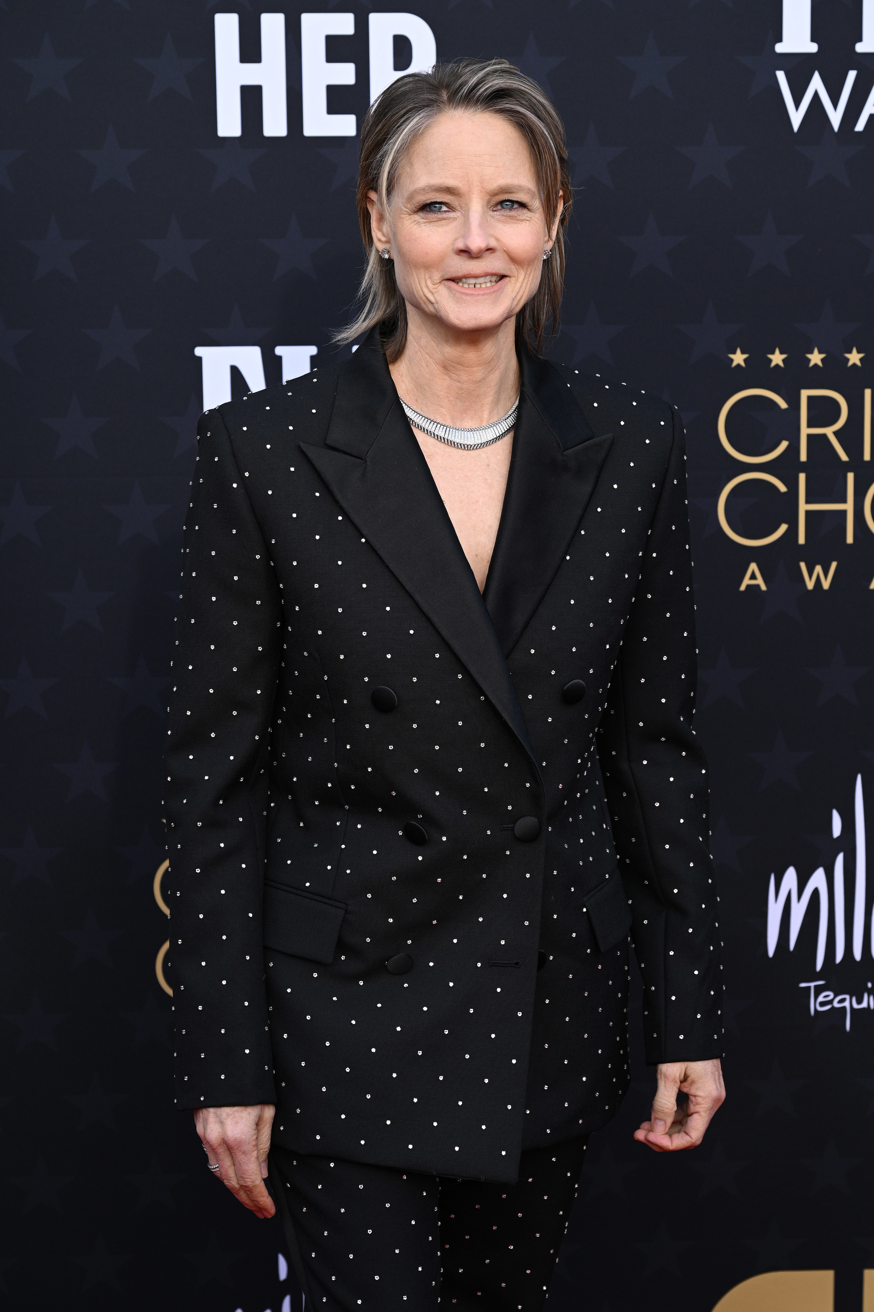 closeup of jodie wearing a studded suit