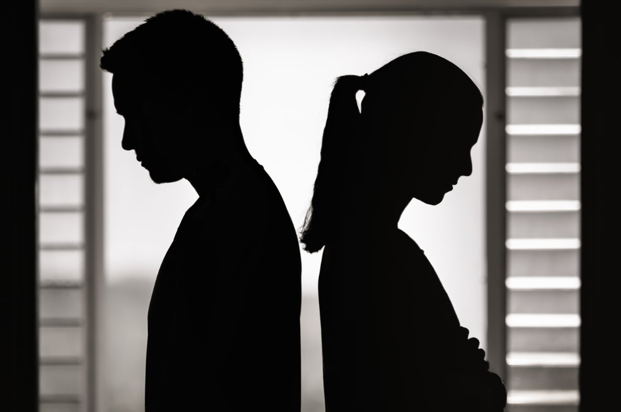 silhouettes of a man and woman not facing each other